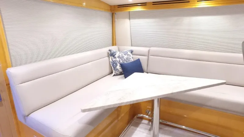 Jolley Roger Yacht Photos Pics 2006 Hatteras Enclosed Bridge yacht interior with plush seating and decorative pillows.