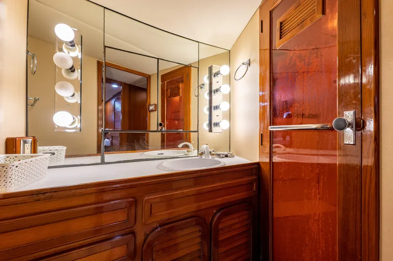  Yacht Photos Pics Luxurious bathroom in 1985 Cheoy Lee 90 Motor Yacht with wood accents and mirrored vanity.