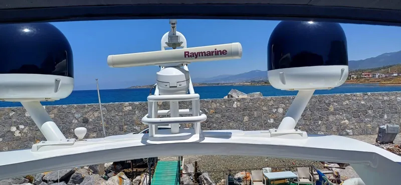  Yacht Photos Pics Radar equipment on a 2006 Sunseeker Manhattan 60 yacht, with ocean and mountains in the background.