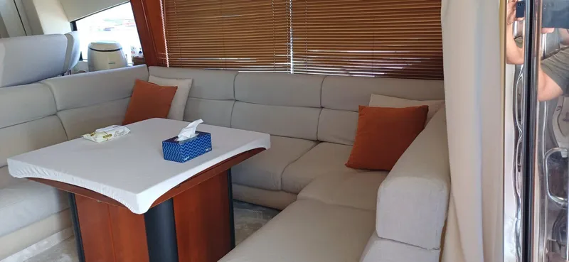  Yacht Photos Pics Luxurious interior of 2006 Sunseeker Manhattan 60 yacht with plush seating and table.