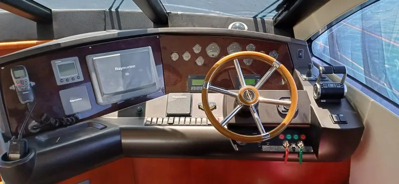  Yacht Photos Pics Helm of 2006 Sunseeker Manhattan 60 yacht with steering wheel and navigation controls.