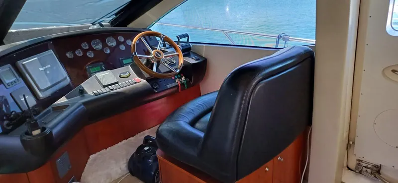  Yacht Photos Pics Helm of 2006 Sunseeker Manhattan 60 yacht with leather seat and wooden steering wheel.