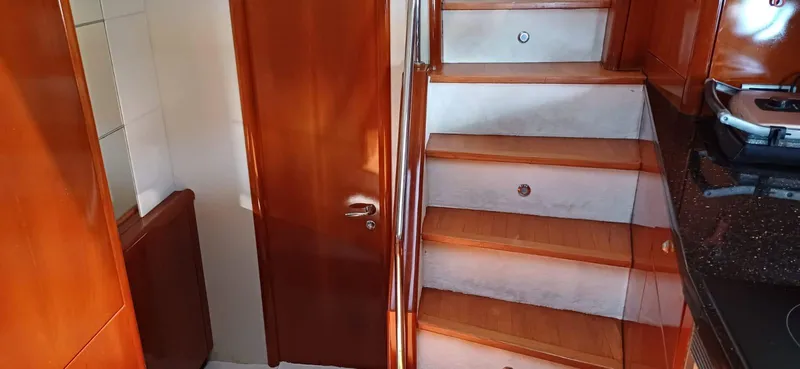  Yacht Photos Pics Interior of 2006 Sunseeker Manhattan 60 yacht with wooden stairs and door.