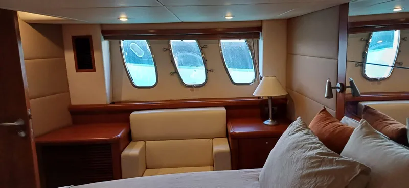  Yacht Photos Pics Luxurious cabin interior of 2006 Sunseeker Manhattan 60 yacht with windows and cozy seating.