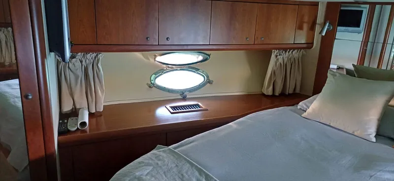  Yacht Photos Pics Luxurious cabin interior of 2006 Sunseeker Manhattan 60 yacht with elegant wood finish.