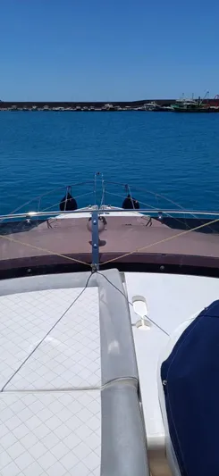  Yacht Photos Pics Sunseeker Manhattan 60 yacht deck view, 2006 model, on calm blue water.