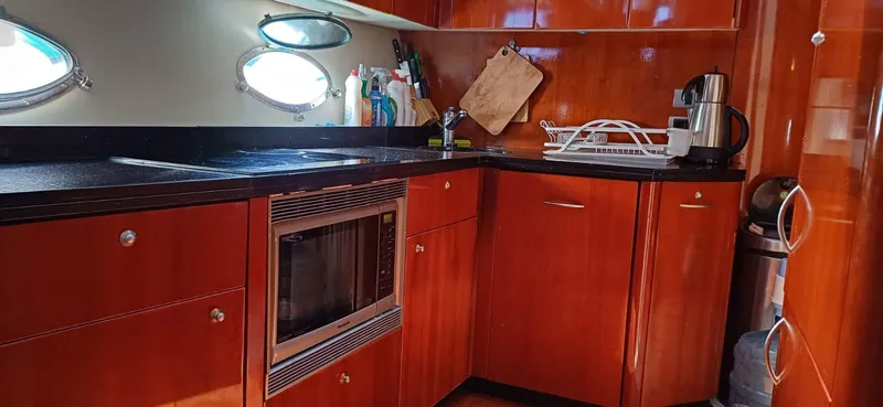  Yacht Photos Pics Luxurious kitchen interior of 2006 Sunseeker Manhattan 60 yacht with wooden cabinetry.