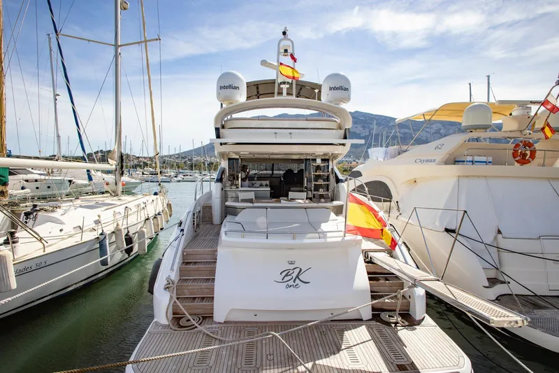  Yacht Photos Pics Luxurious 2022 Princess S66 yacht docked in a scenic marina setting.