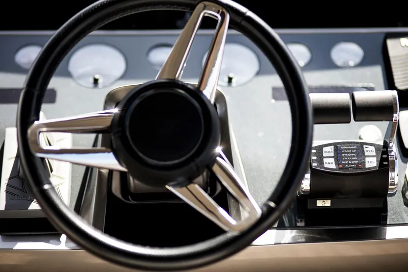  Yacht Photos Pics Steering wheel and controls of 2022 Princess S66 yacht cockpit.