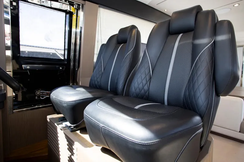  Yacht Photos Pics Luxurious black leather seats in 2022 Princess S66 yacht interior.