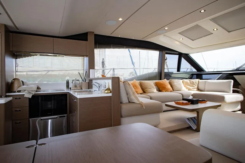  Yacht Photos Pics Luxurious interior of 2022 Princess S66 yacht with modern kitchen and cozy seating area.