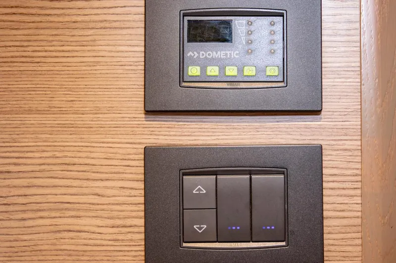  Yacht Photos Pics Control panels on wood paneling in 2022 Princess S66 yacht interior.