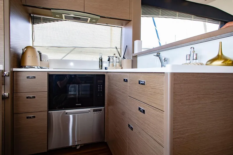 Yacht Photos Pics Modern kitchen interior on 2022 Princess S66 yacht with sleek cabinetry and appliances.