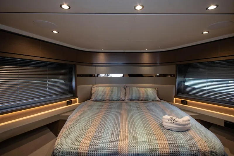  Yacht Photos Pics Luxurious bedroom interior of 2022 Princess S66 yacht with modern lighting and elegant bedding.