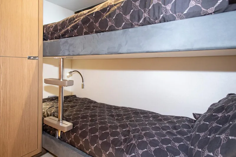  Yacht Photos Pics Bunk beds in 2022 Princess S66 yacht cabin with modern design and patterned bedding.