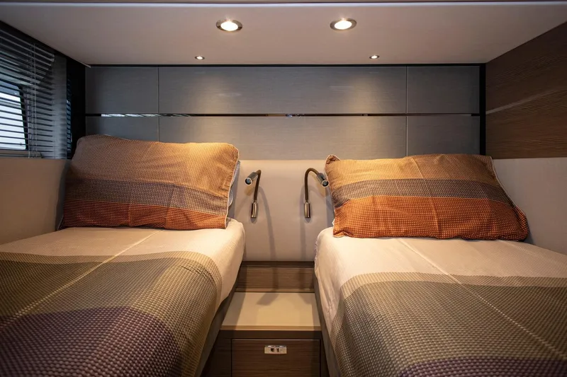  Yacht Photos Pics Luxurious twin cabin interior of 2022 Princess S66 yacht with modern lighting.