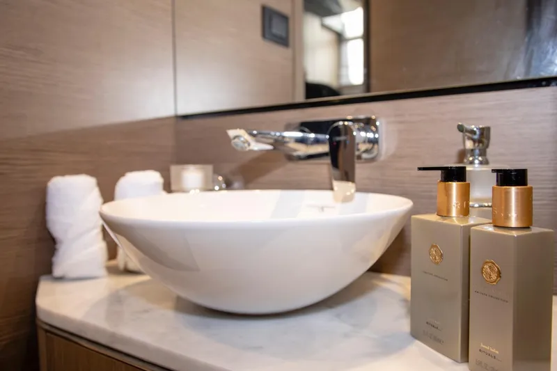  Yacht Photos Pics Luxurious bathroom sink with elegant toiletries on a 2022 Princess S66 yacht.