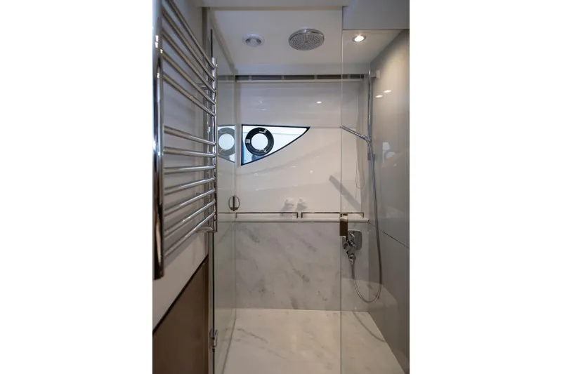  Yacht Photos Pics Luxurious bathroom in 2022 Princess S66 yacht with glass shower and modern fixtures.