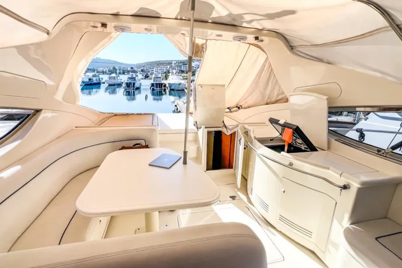  Yacht Photos Pics Luxurious 2001 Cantieri di Sarnico 45 yacht interior with elegant seating and marina view.