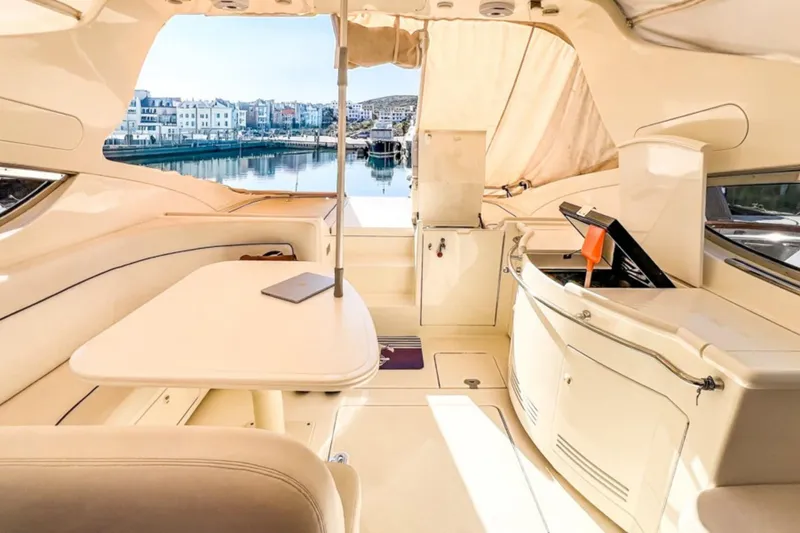  Yacht Photos Pics Luxurious interior of 2001 Cantieri di Sarnico 45 yacht with elegant seating and waterfront view.