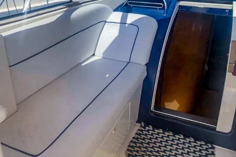  Yacht Photos Pics Interior of 2001 Cantieri di Sarnico 45 yacht with white seating and cabin entrance.