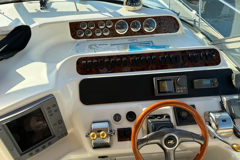  Yacht Photos Pics 1998 Sea Ray 400 Sundancer helm with gauges, controls, and navigation equipment.