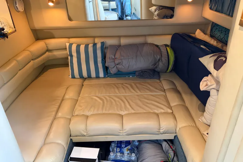  Yacht Photos Pics 1998 Sea Ray 400 Sundancer cabin interior with beige seating and striped pillows.