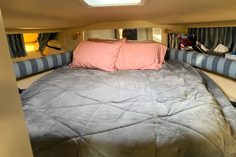  Yacht Photos Pics Cozy cabin interior of 1998 Sea Ray 400 Sundancer with bed and pillows.