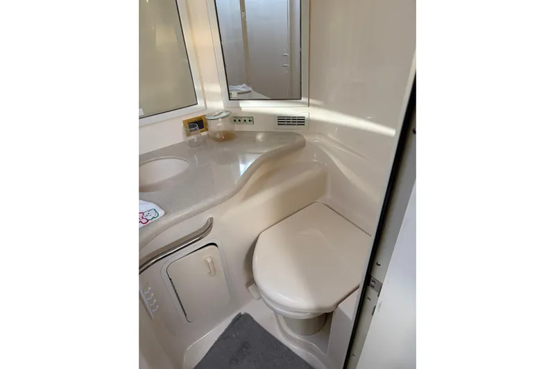  Yacht Photos Pics Bathroom interior of 1998 Sea Ray 400 Sundancer yacht, featuring sink and toilet.