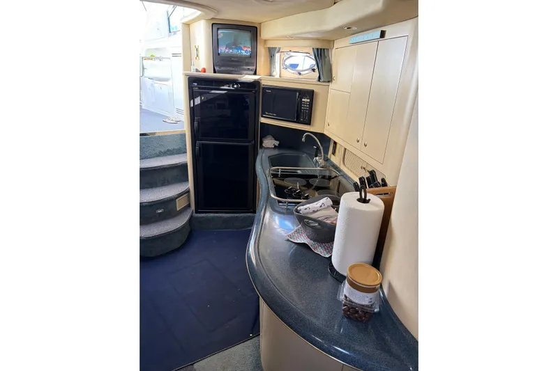  Yacht Photos Pics 1998 Sea Ray 400 Sundancer yacht interior with kitchenette, microwave, and TV.