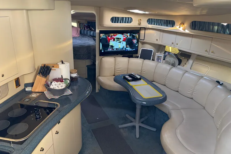  Yacht Photos Pics Interior of 1998 Sea Ray 400 Sundancer yacht with kitchen, seating, and TV.