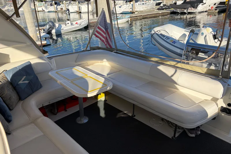  Yacht Photos Pics 1998 Sea Ray 400 Sundancer yacht interior with seating and table, docked at marina.