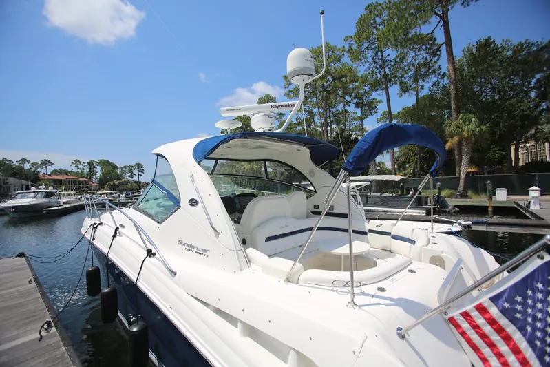 Missy Yacht Photos Pics 2010 Sea Ray 390 Sundancer yacht docked at marina, featuring sleek design and American flag.