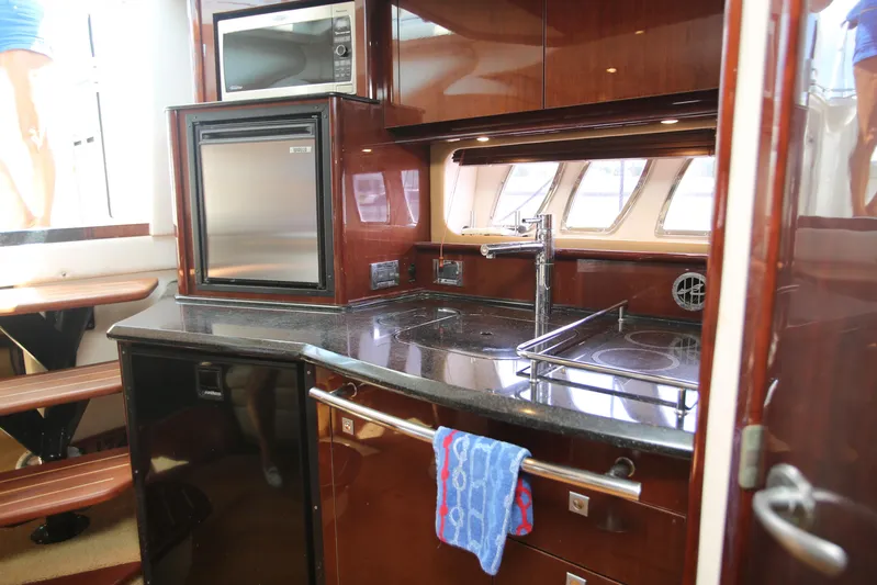 Missy Yacht Photos Pics Luxurious kitchen area in a 2010 Sea Ray 390 Sundancer yacht, featuring modern appliances.