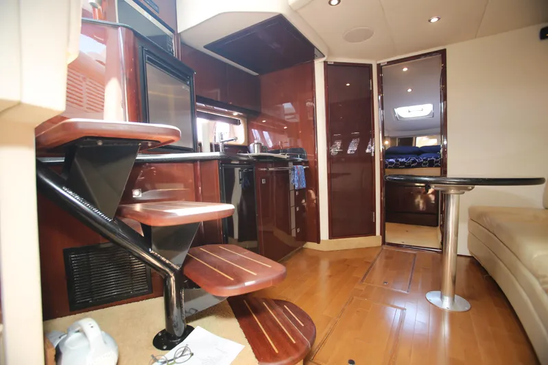 Missy Yacht Photos Pics Interior of 2010 Sea Ray 390 Sundancer yacht with modern kitchen and wooden stairs.
