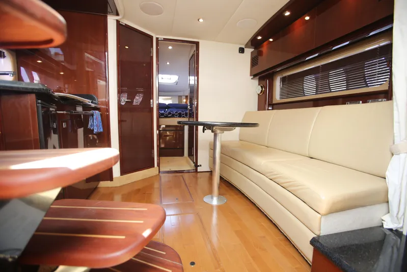 Missy Yacht Photos Pics Interior of 2010 Sea Ray 390 Sundancer yacht with beige seating and wooden finishes.