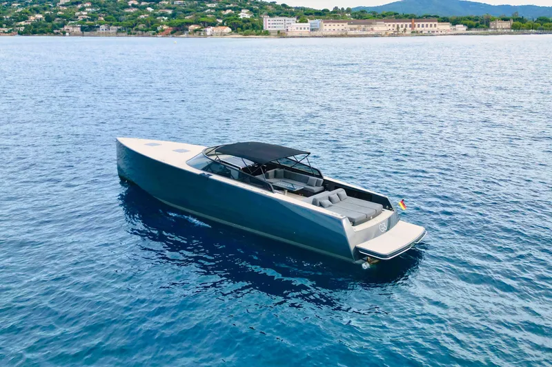 G3 Yacht Photos Pics Luxury 2013 VanDutch 55 yacht on serene blue waters, coastal backdrop.