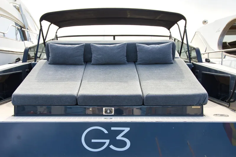 G3 Yacht Photos Pics 2013 VanDutch 55 yacht with cushioned sunbed and canopy, featuring "G3" branding.