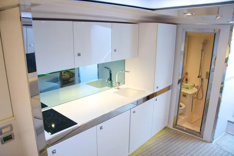 G3 Yacht Photos Pics Modern interior of 2013 VanDutch 55 yacht with sleek kitchen and compact bathroom.