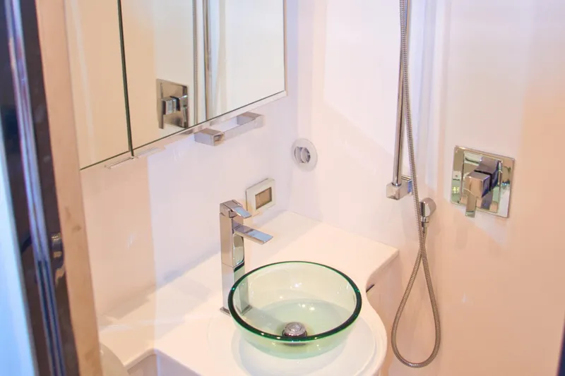 G3 Yacht Photos Pics Modern bathroom in 2013 VanDutch 55 yacht with glass sink and sleek fixtures.