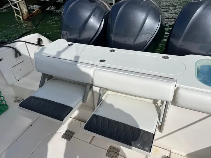  Yacht Photos Pics 2014 Everglades 350LX boat with triple outboard engines and seating area.