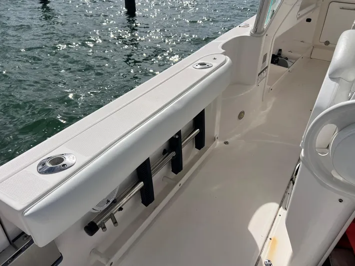  Yacht Photos Pics 2014 Everglades 350LX boat interior with rod holders and seating, near water.