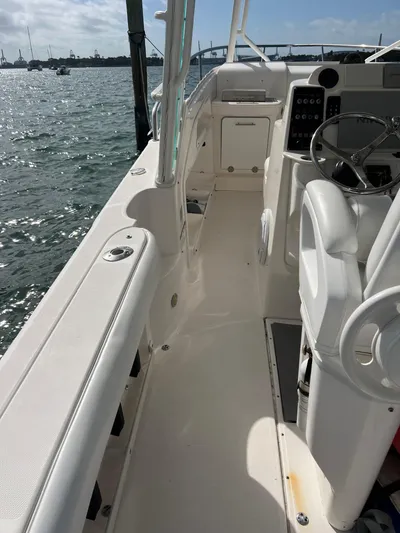  Yacht Photos Pics 2014 Everglades 350LX boat interior with steering wheel and seating, docked by the water.