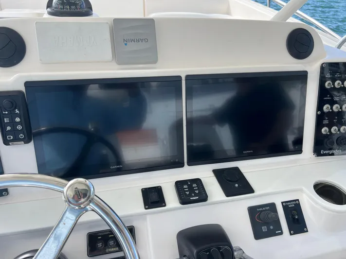  Yacht Photos Pics 2014 Everglades 350LX boat dashboard with dual Garmin displays and steering wheel.