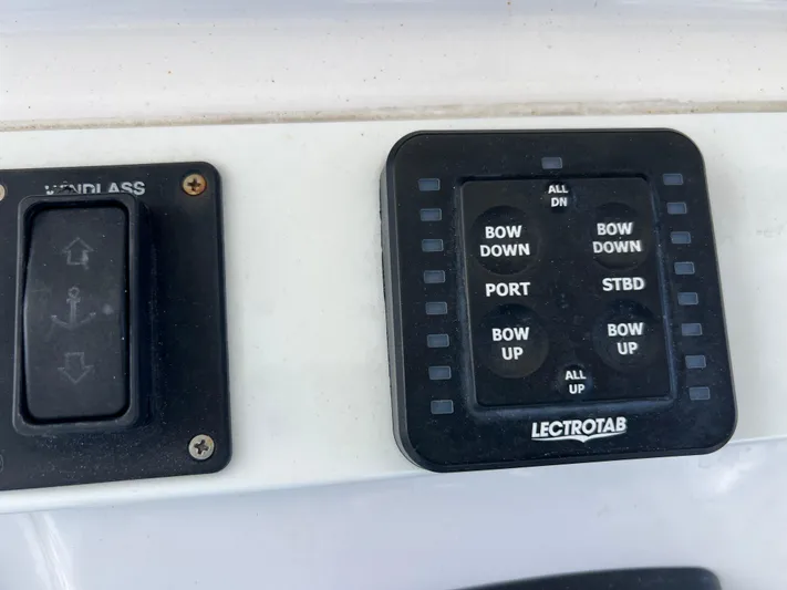  Yacht Photos Pics Control panel of a 2014 Everglades 350LX boat with windlass and Lectrotab trim tab switches.