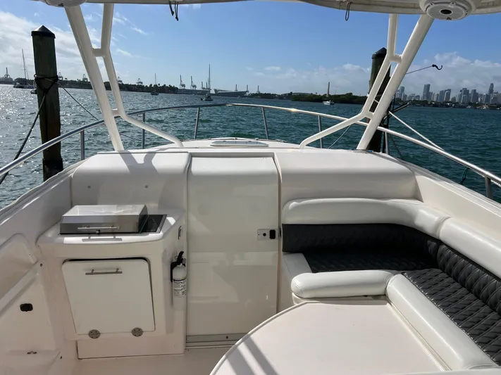  Yacht Photos Pics 2014 Everglades 350LX boat interior with seating, ocean view, and city skyline.