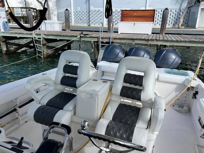  Yacht Photos Pics 2014 Everglades 350LX boat interior with dual leather seats and triple outboard motors.