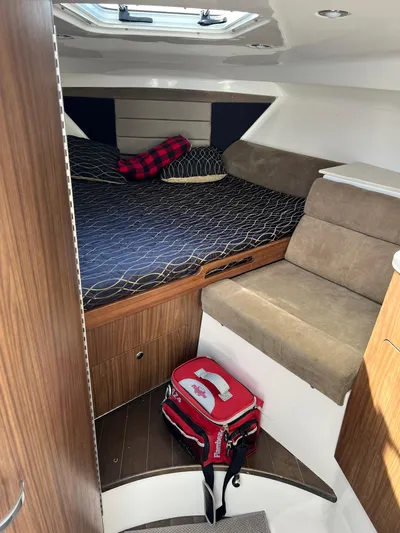  Yacht Photos Pics Interior cabin of 2014 Everglades 350LX boat with bed and seating area.