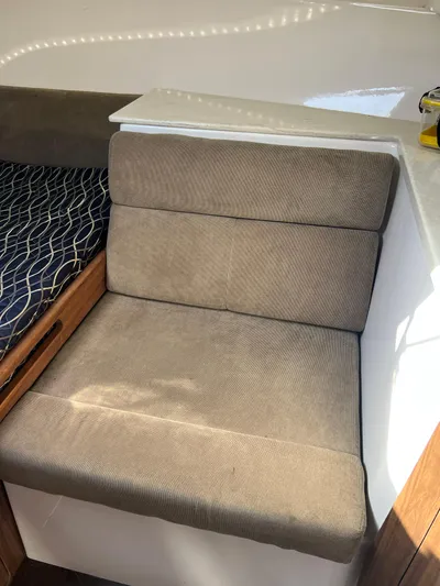  Yacht Photos Pics 2014 Everglades 350LX interior seating with beige upholstery and adjacent bed.