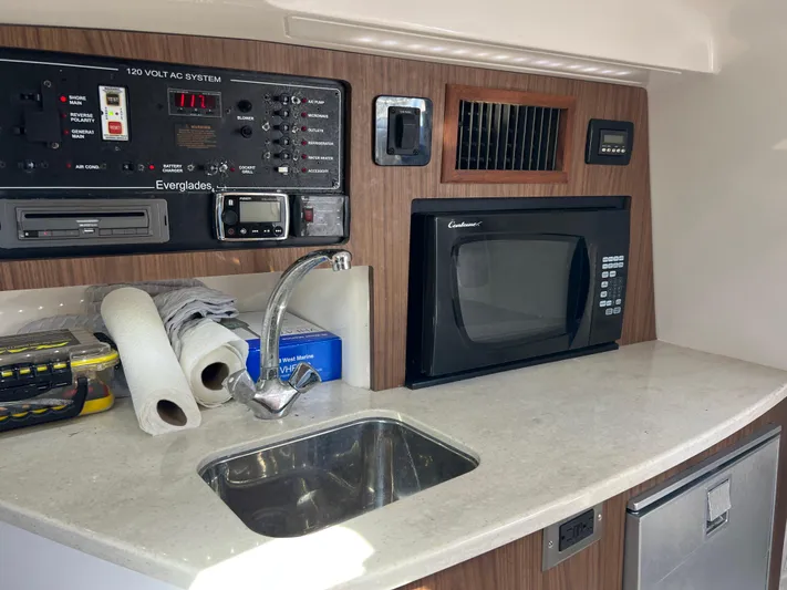  Yacht Photos Pics 2014 Everglades 350LX boat interior with sink, microwave, and control panel.